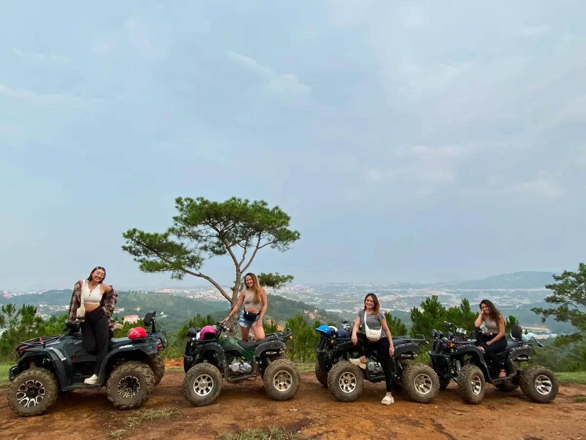 a group having a photoshoot on atvs.