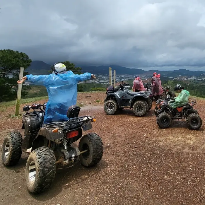 a group having a photoshoot on atvs in the rain.