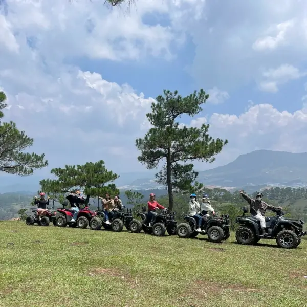 a group having a photoshoot on atvs.