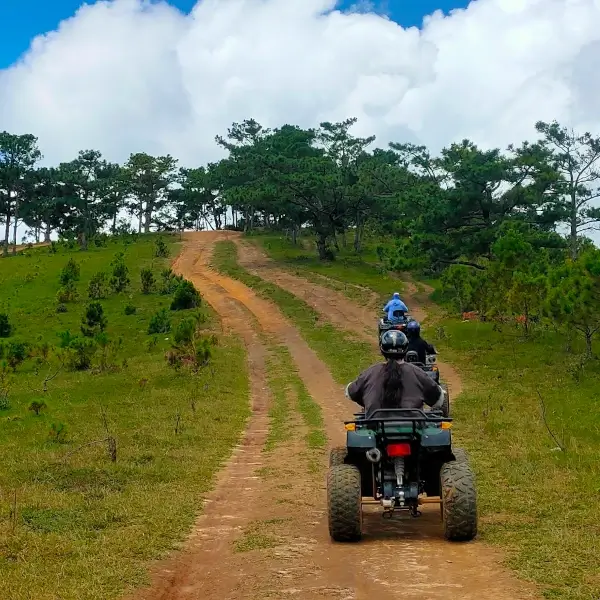 three atvs riding up a mountain.