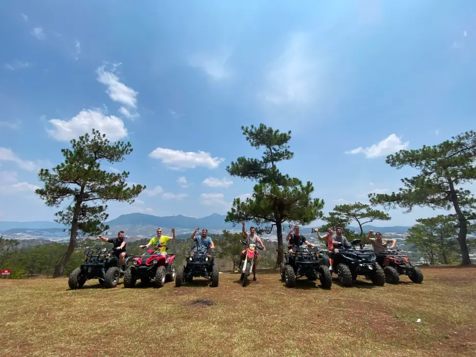 a group on atvs stopped for a group photo.