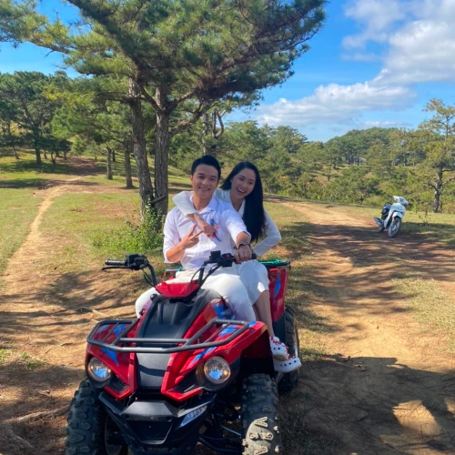 a couple sitting together on an atv.