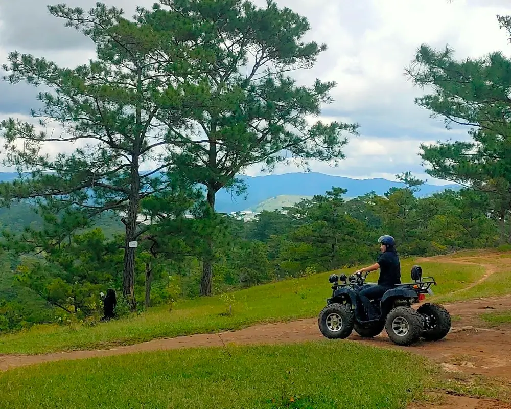 a girl on an atv in the hills of da lat.