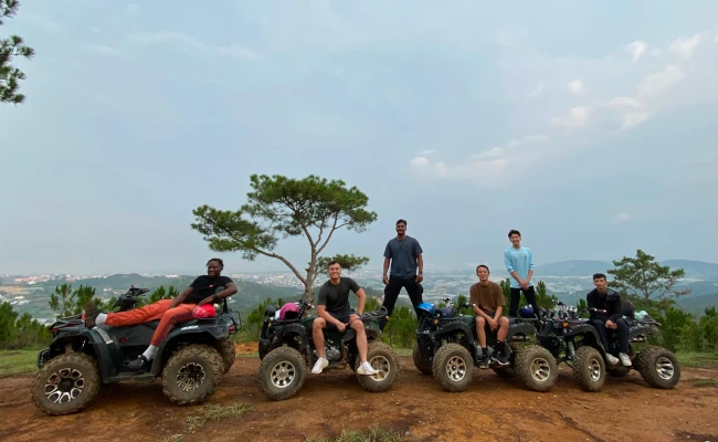 a group on atvs stopped for a group photo.